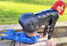 shiny pvc slut in blue boots in the sunshine